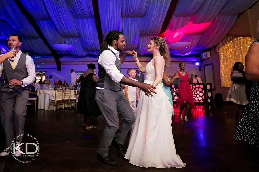 A couple on the dance floor with their DJ on the microphone