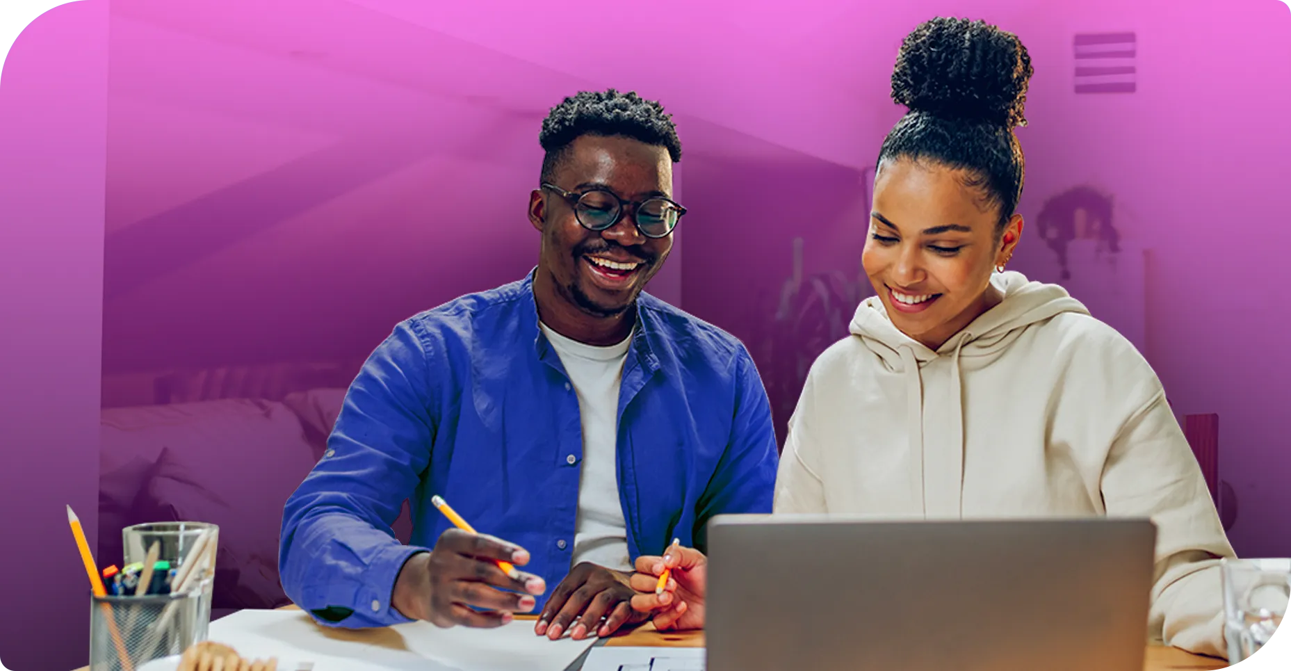 A couple planning their wedding music on a laptop