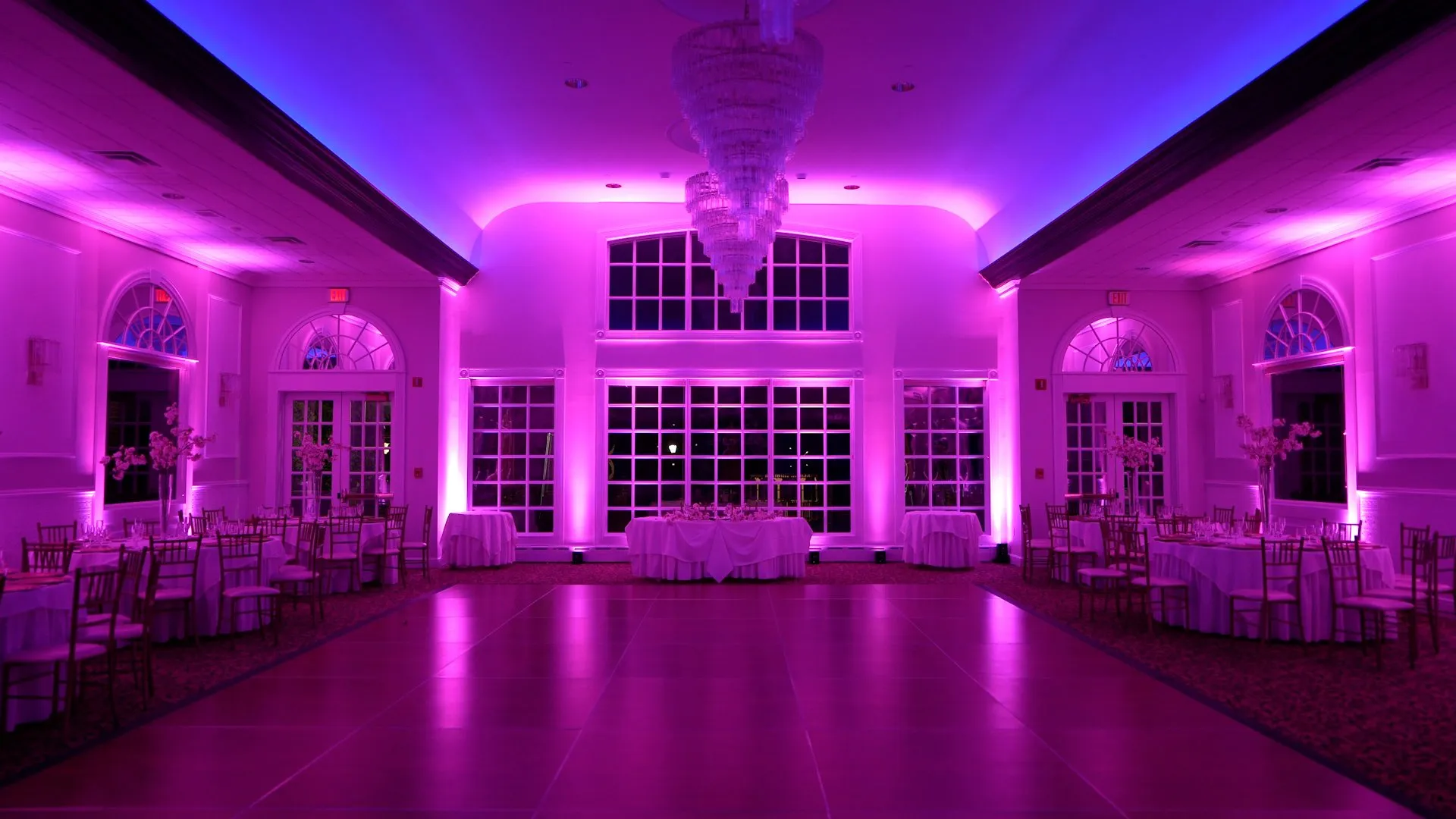 A reception room washed in pink uplighting