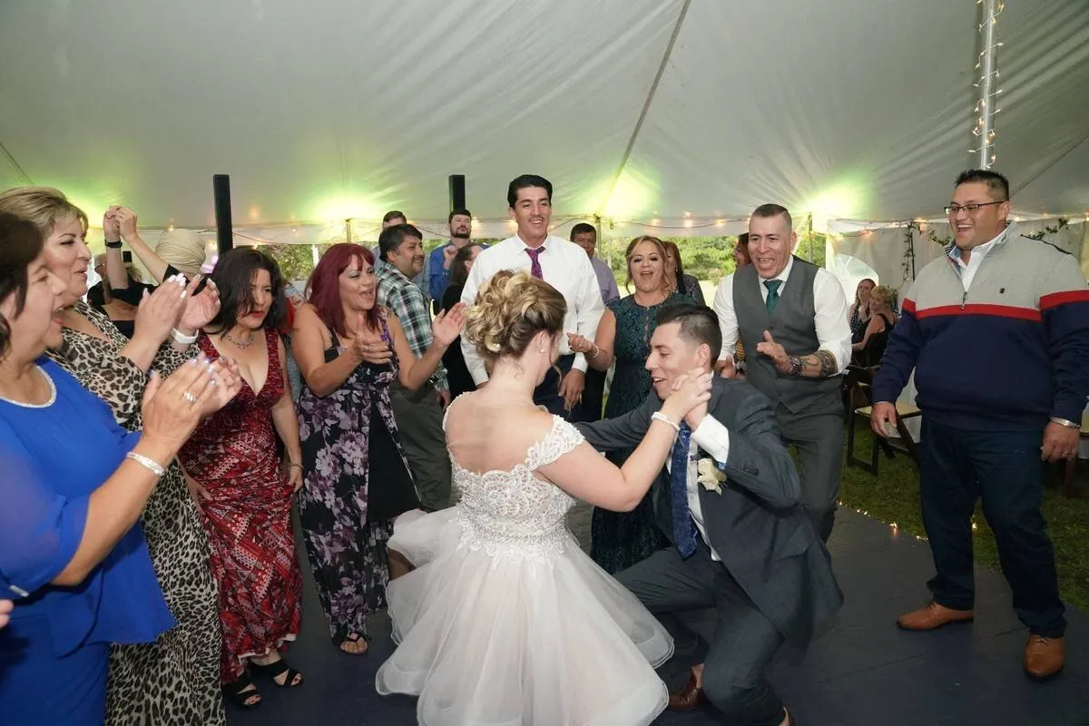The bride and groom dancing under the tent