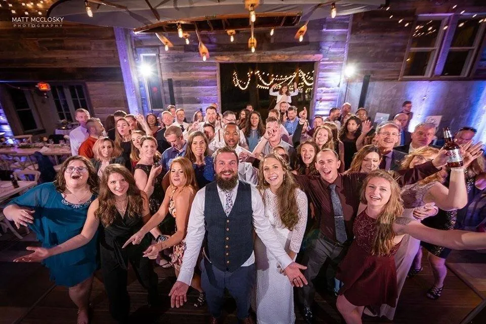Wedding guests dancing with the couple